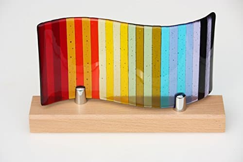 Fused glass rainbow panel, a decorative glass panel with rainbow stripes moulded into a wave shape, mounted on a beech wood base